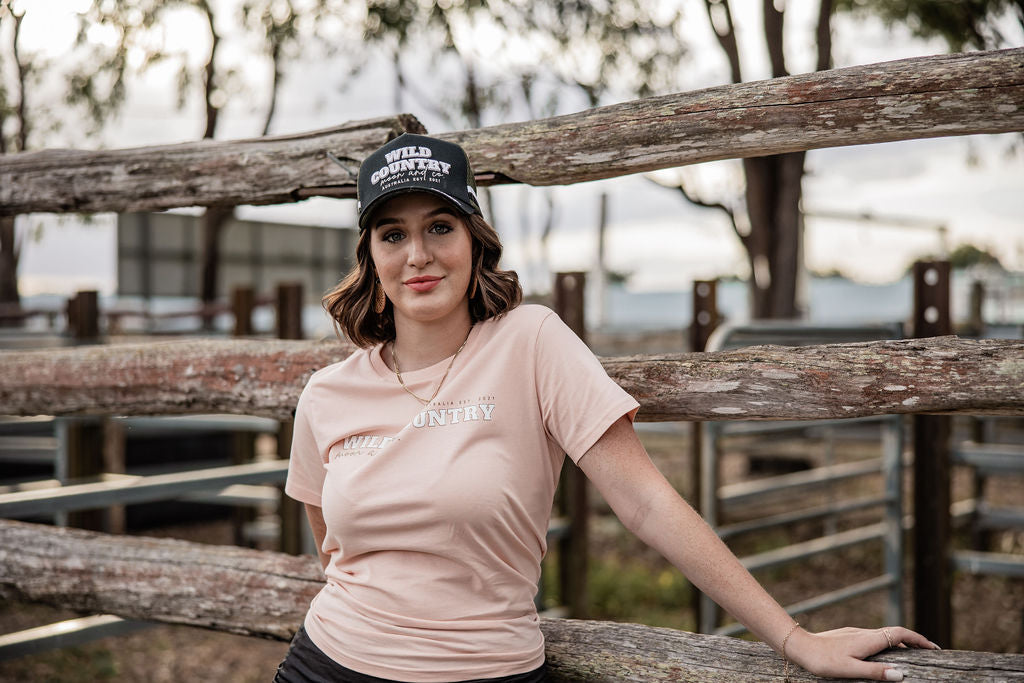 From "baling" hay to getting"bailed" up by cattle in the yards, our BALED UP Tee in Pale Pink is a wardrobe essential. Go from paddock to pub with this simple chest design&nbsp;tee.&nbsp;